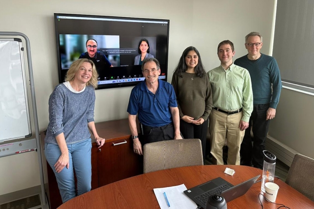 Nastaran Nagshineh is shown with other faculty in a small room where she defended her thesis.