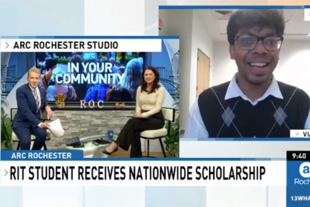 a man and a woman sit on chairs in the lower left of the screen. in the upper right, an R I T student appears to speak to them virtually.