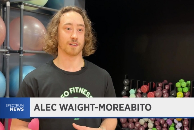 Alec Waight-Morabito a college age male is shown on TV with a chyron showing his name underneath.