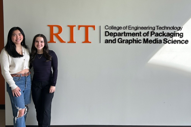Two students pose against a wall for Deptartment of Packaging and Graphic Media Science.