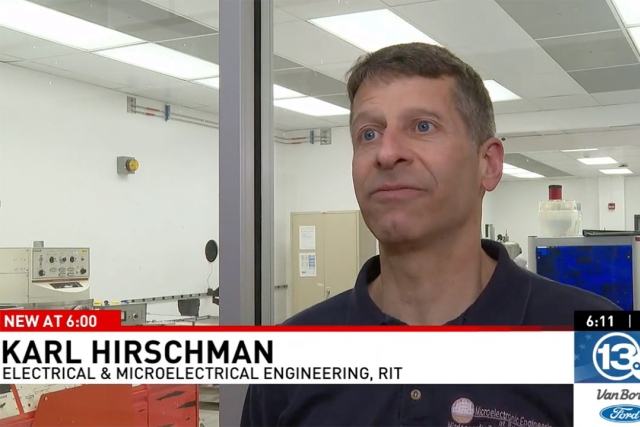 Karl Hirchman stands in a chip lab setting with a chyron from W H A M 13 at the bottom. 