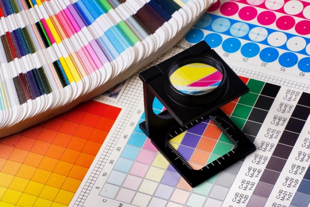 Graphic pantone samples and a magnify glass for looking at a rainbow of colors. 