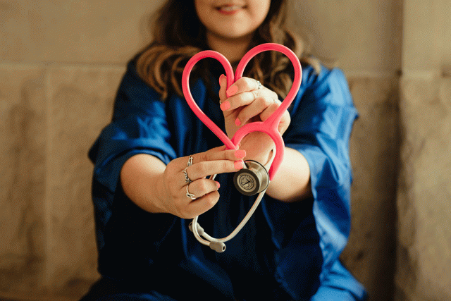 Person holds stethoscope in the shape of a heart
