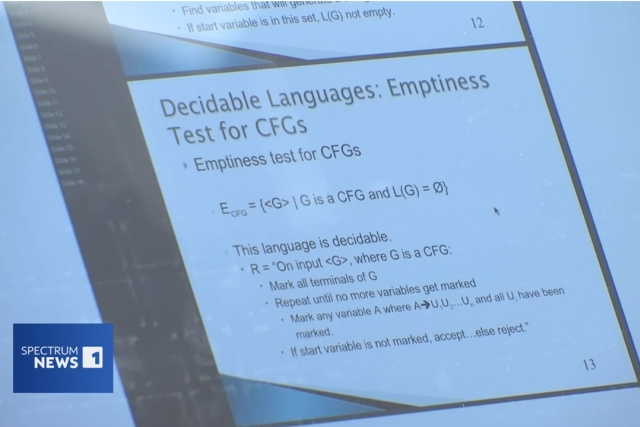 artificial intelligence and computer science concepts are displayed on a white board in a classroom.