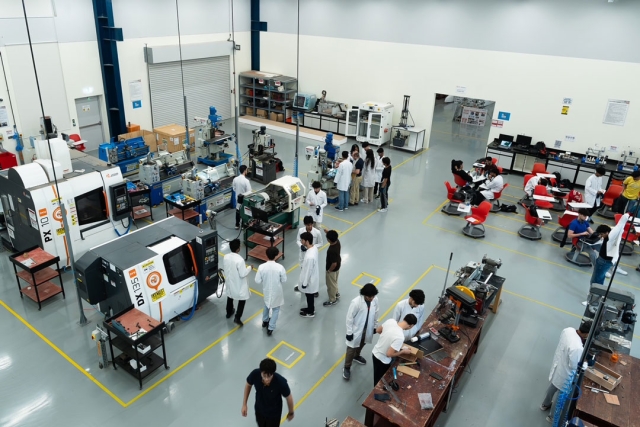 many people stand scattered in a computer engineering lab in Dubai