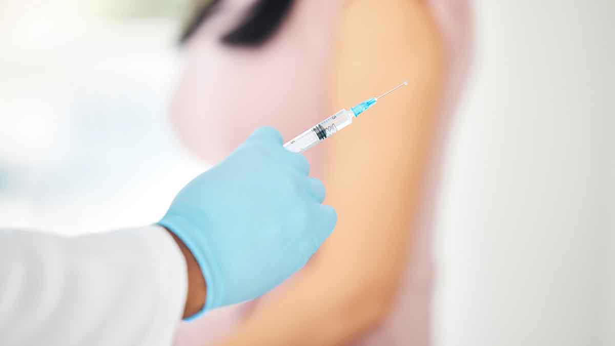 Close up of a doctor holding a syringe.