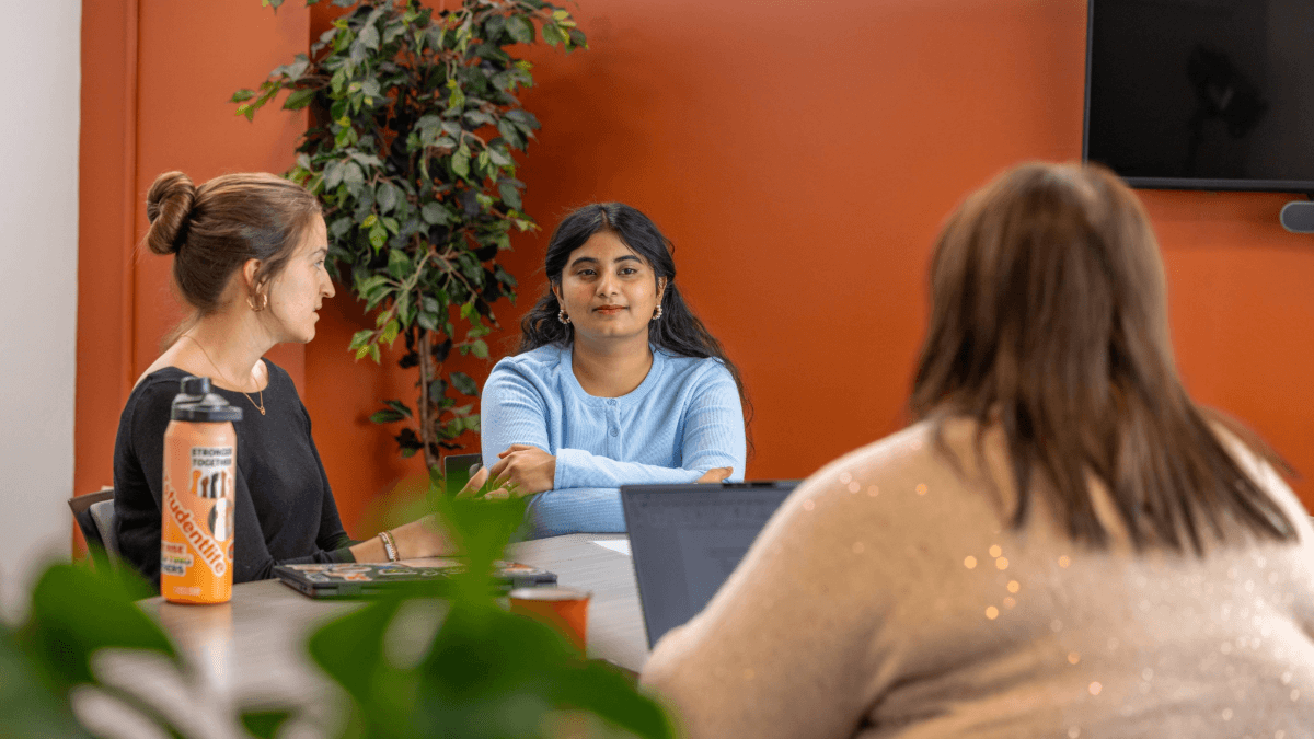 A student and staff sitting at a table having a calm discussion