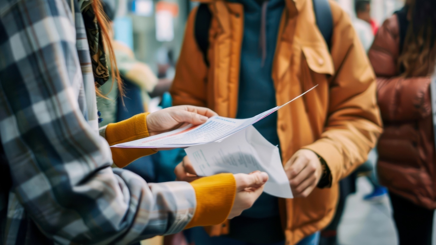 students reviewing papers while walking