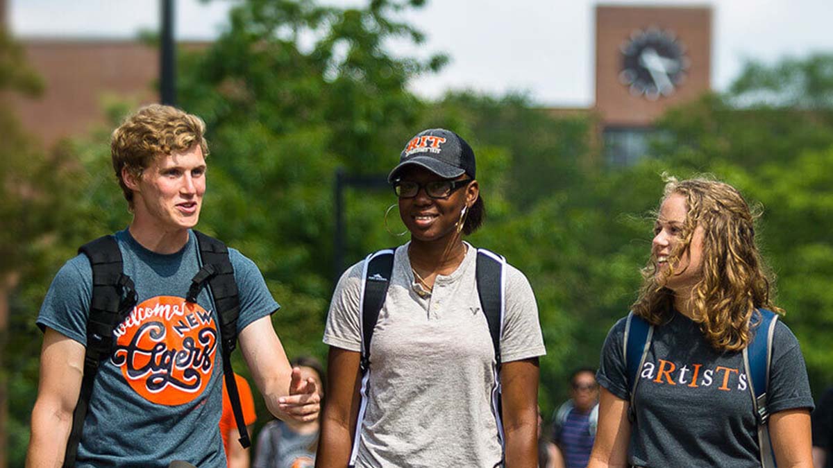 Three students walking down the Quarter Mile.