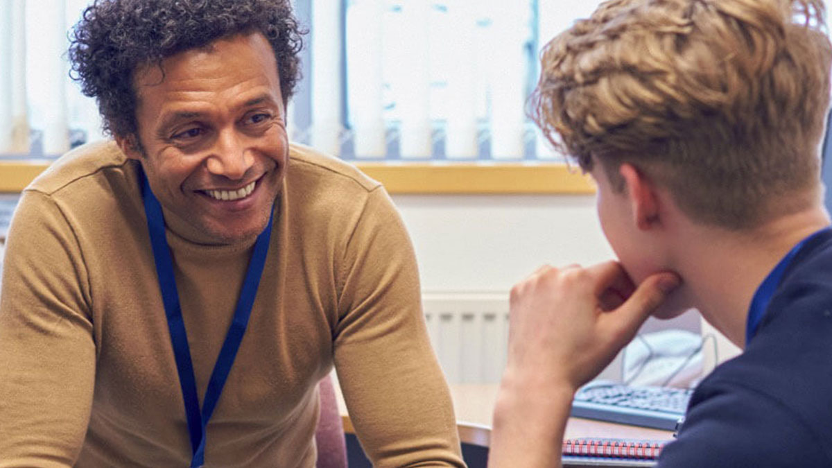 An advocate talking with a student in an office setting.