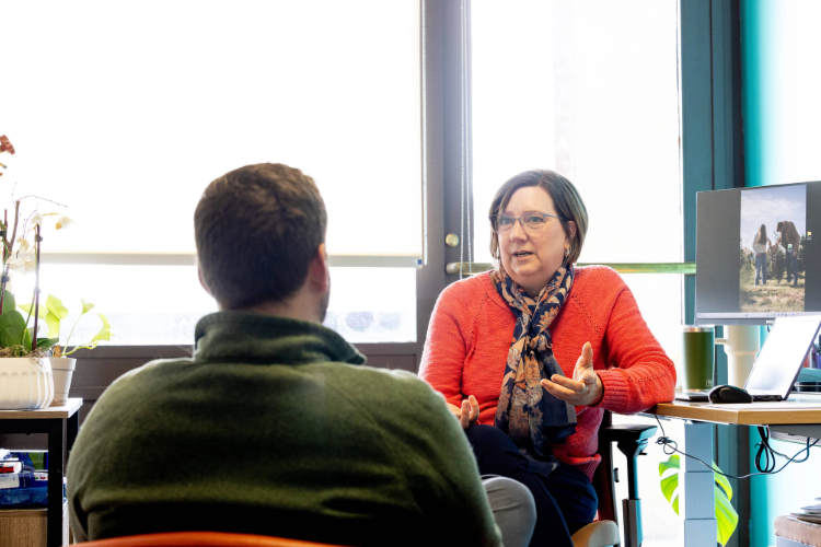 A conversation between student and professional sitting in the student conduct and conflict resolution office 
