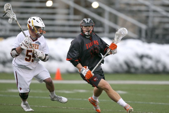 People playing lacrosse on field