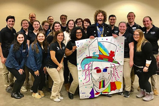 Members of the College Activities Board pose for a photo with T.J. Miller.