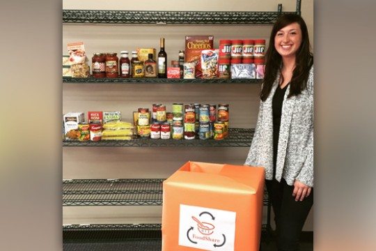 Person posing by shelfs with food