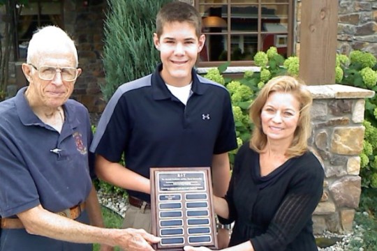 People posing with award