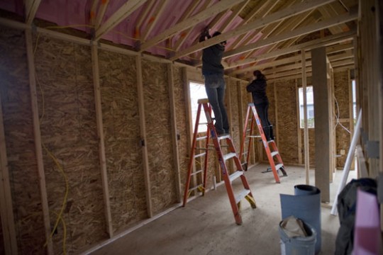 People building house
