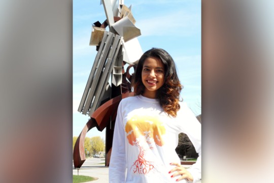 Person posing in front of statue