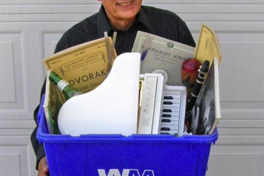 Person holding recycling bin