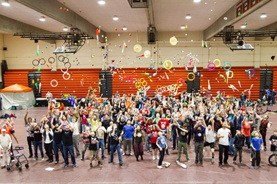 People throwing juggling equipment in the air