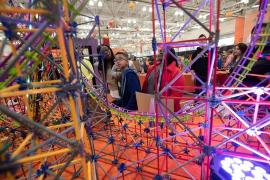 Student looks at rollercoaster made from K'Nex.