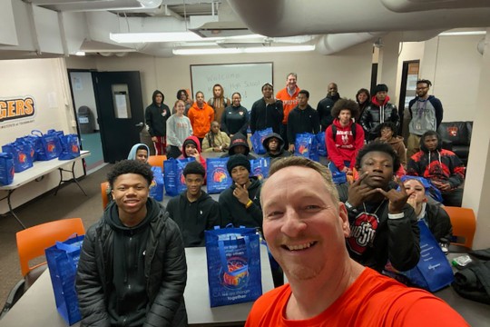 Group selfie in a classroom with student athletes.