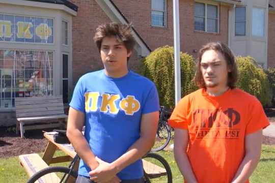 two college students wearing fraternity T shirts.