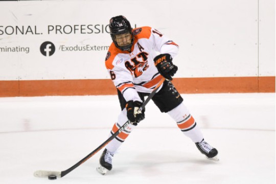 Elijah Gonsalves is shown on the ice during a hockey game.