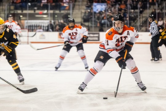 Carter Wilkie and other members of the RIT men’s hockey  team are shown playing during a recent game.