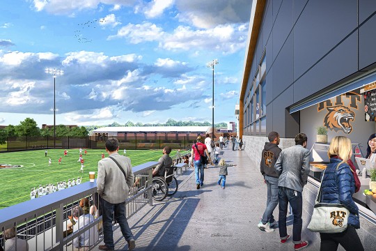 a generated image of the new main concourse of a staium is displayed with the field to the left and a concession stand to the right.