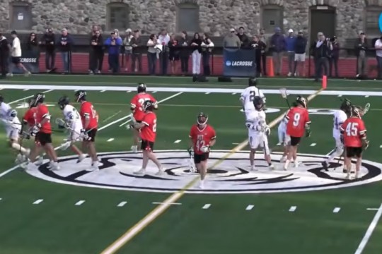 the R I T mens lacrosse team spreads across a playing field