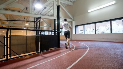 An indoor track with a runner 