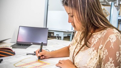 Architecture student draws sketch.