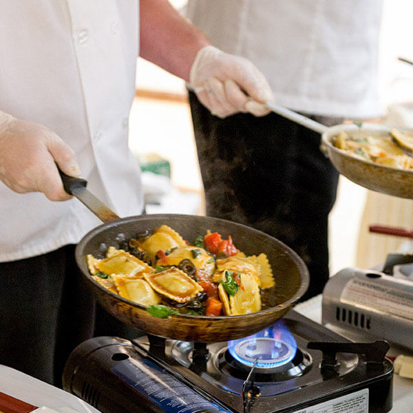 Chef cooking food over a burner
