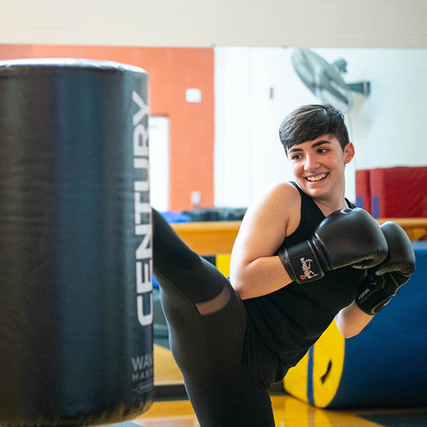 A student participating in a kickboxing class