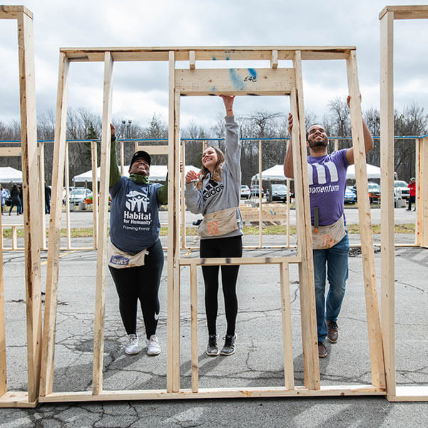 RIT students helping frame a house