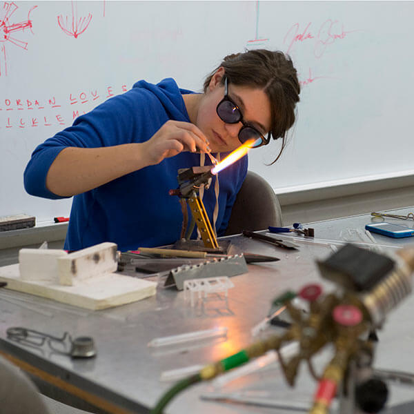 An RIT student in a studio class