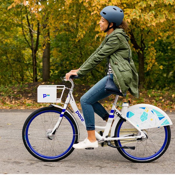 An RIT student riding a Pace bike