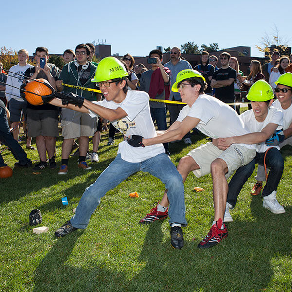 A team of RIT students getting ready to project a pumpkin through the air via their machine