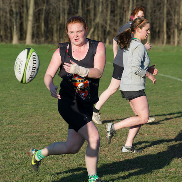 Three women playing rugby