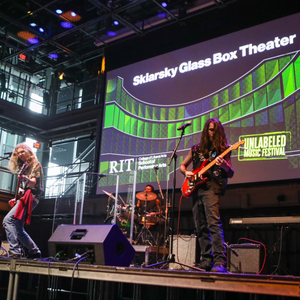 A group of students in a band playing at the Unlabeled Music Festival