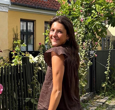 Grace Validzic in front of flowers 