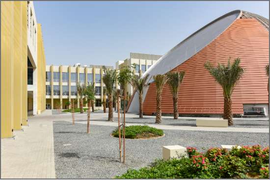 The RIT Dubai campus features modern architecture, including a distinctive dome structure, palm trees, and a landscaped courtyard.