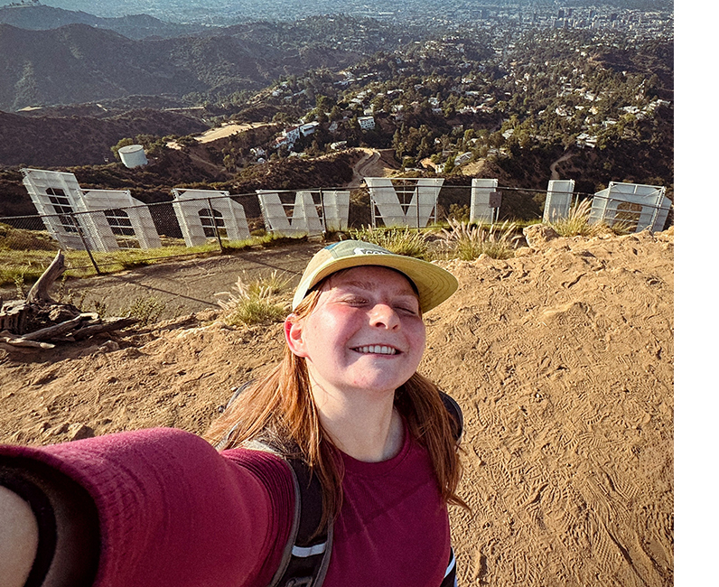Student posing in front of Hollywood sign
