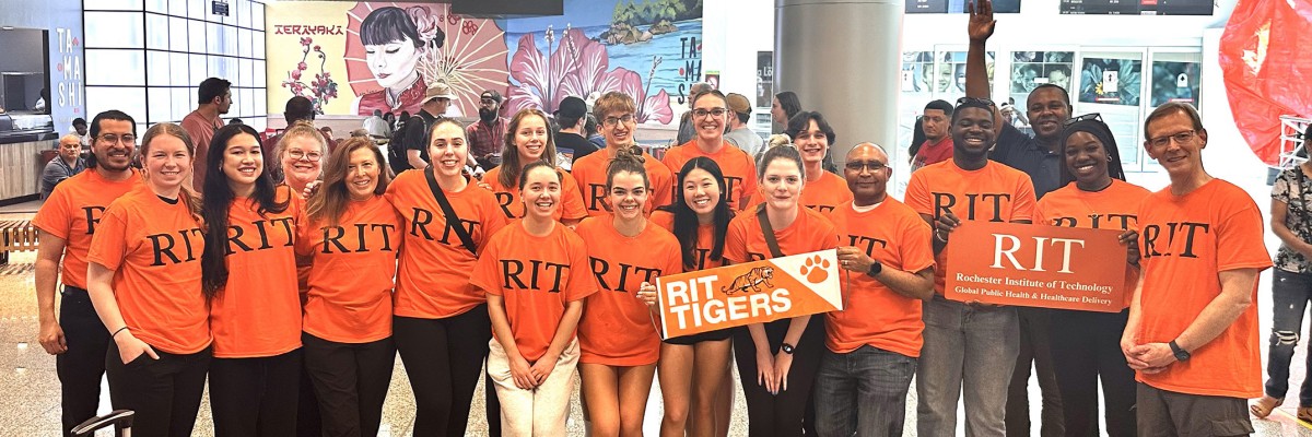 Group of RIT students in the Dominican Republic holding an RIT banner