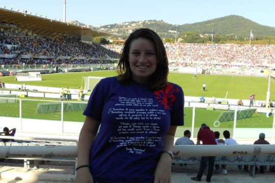 Person posing in front of field
