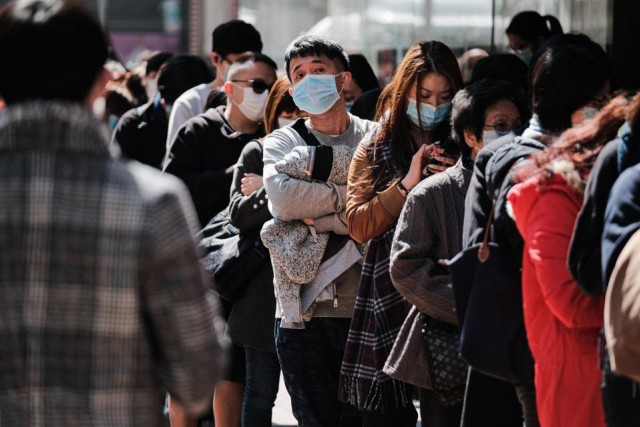 crowd of people wearing surgical masks.