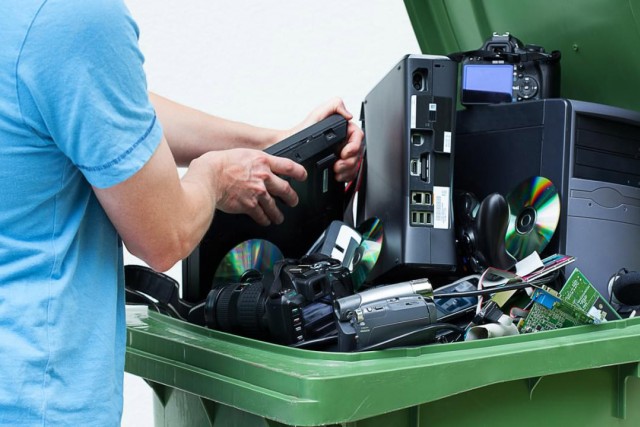 recycling tote full of eletronic devices.