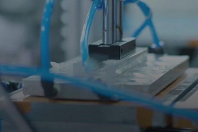 Machining tool with blue wires.