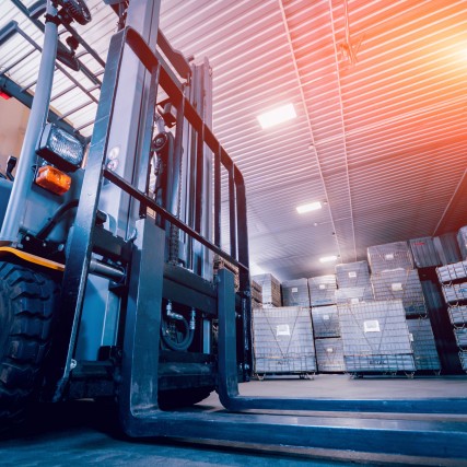 A forklift awaits inventory in a warehouse