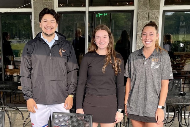 three college students posing for a photo.